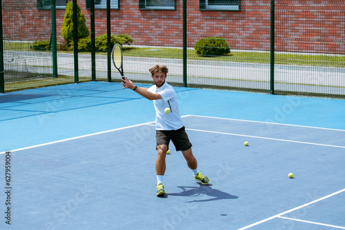 Tennis player training on a professional tennis court. © VIAR PRO studio