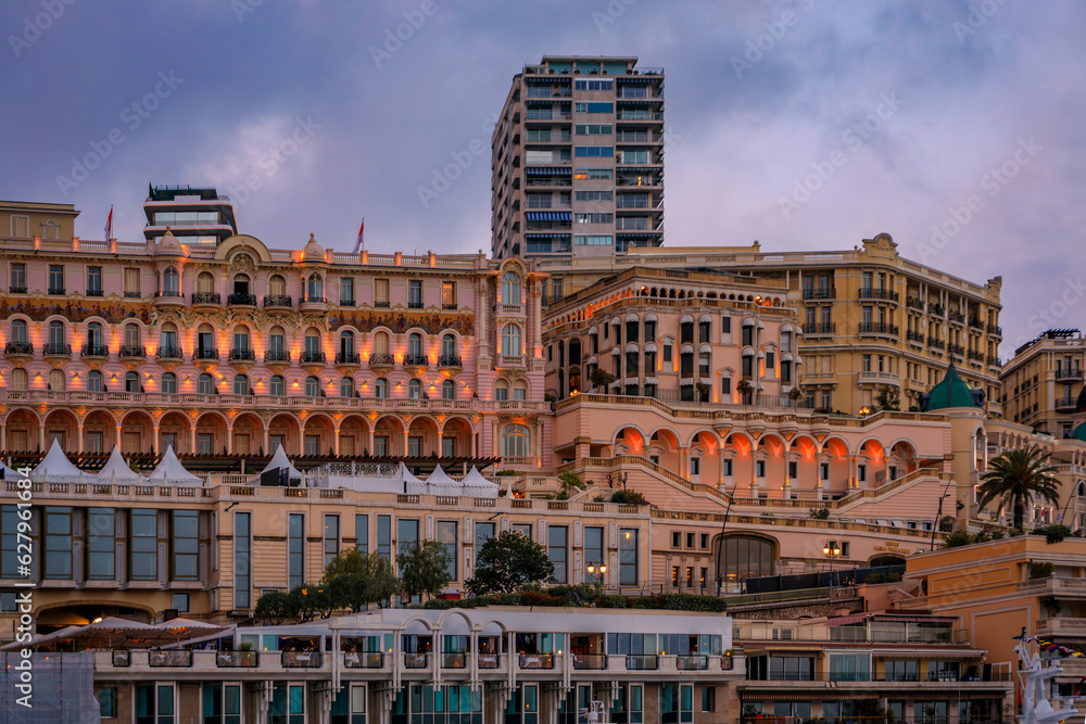 Monte Carlo cityscape with luxury apartment buildings by the port of Monaco, Cote d'Azur on the French Riviera at the golden hour of sunset
