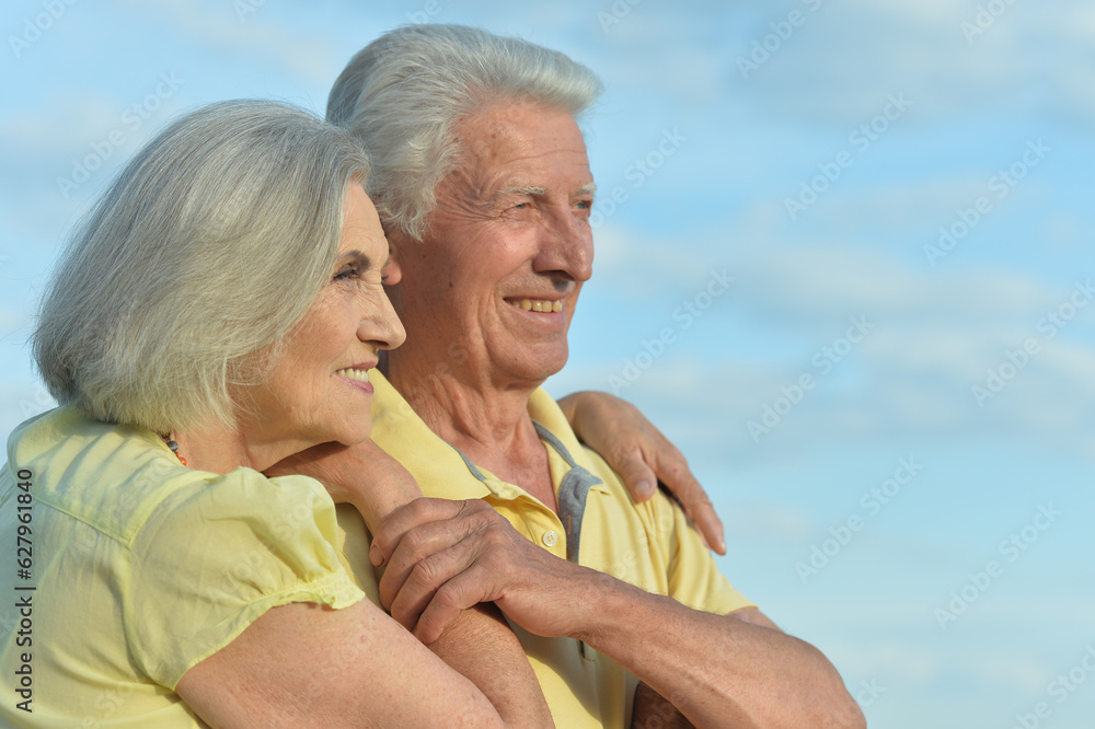 Beautiful Caucasian aged couple outdoors on a sky background