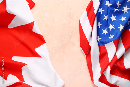 Fototapeta Naklejka Na Ścianę i Meble -  Flags of USA and Canada on beige background