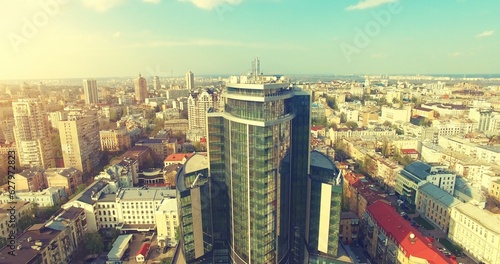 Aerial Drone Flight: Picturesque view on cityscape with glass business center in sunset light. Flight over the Boulevard of Taras Shevchenko, Kiev, Ukraine, Europe. photo
