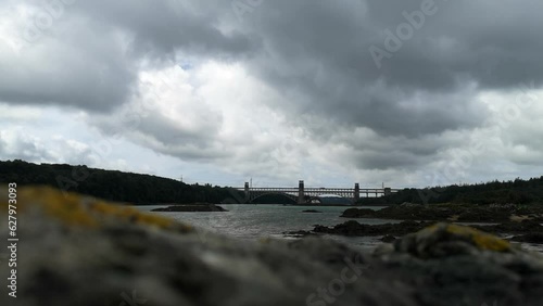 Wallpaper Mural Looking over unfocused rock foreground to overcast Menai Straits Britannia bridge to Anglesey Torontodigital.ca