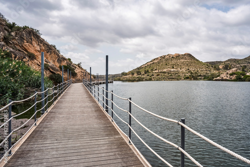 Footbridge in the Elche reservoir. In this footbridge you can see the nature of the environment. In Elche, Alicante, Valencian community, Spain © Jose Aldeguer