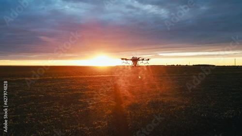 agricultural drones fly into the sunset over the field and spray fertilizer view from above 4k photo