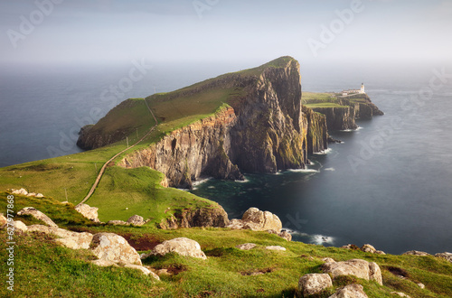 Photo A view of the Neist Point Lighthouse on the green cliffs of the Isle of Skye