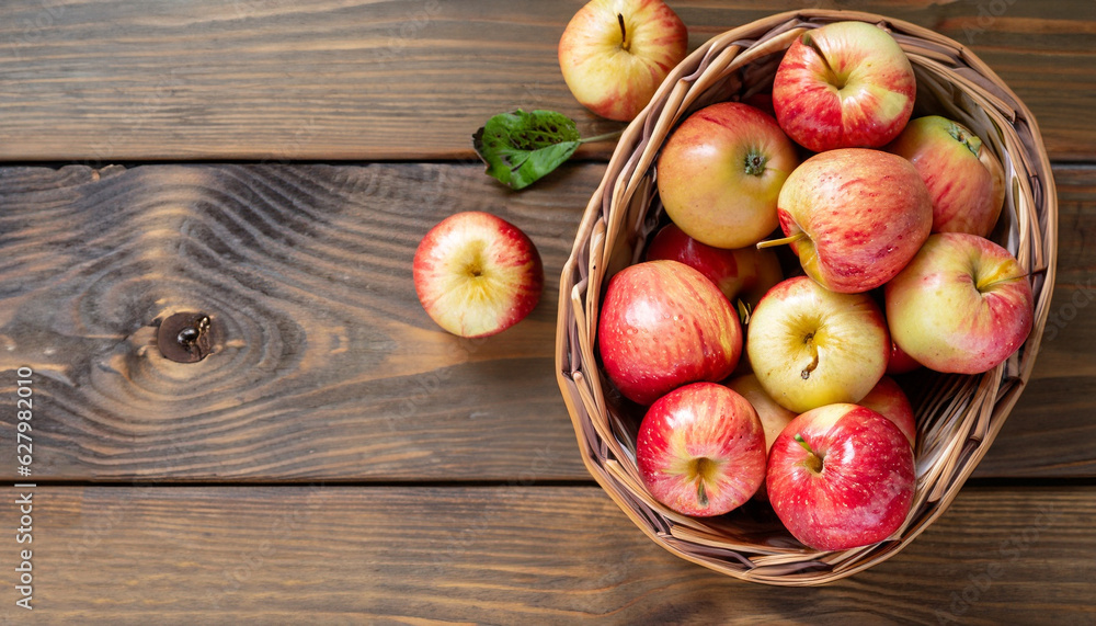 Ripe garden apple fruits in basket on wooden table. Top view flat lay with copy space Ripe garden apple fruits in basket on wooden table. Top view flat lay with copy space