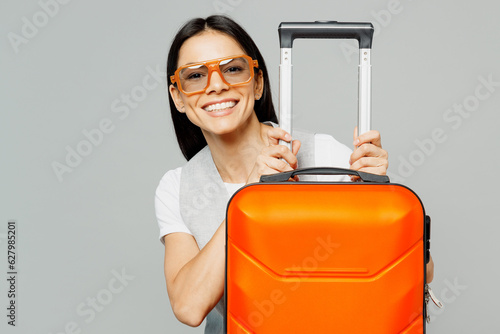 Traveler latin woman wears summer casual clothes hold suitcase isolated on plain grey color background studio. Tourist travel abroad in free spare time rest getaway. Air flight trip journey concept. #627985201