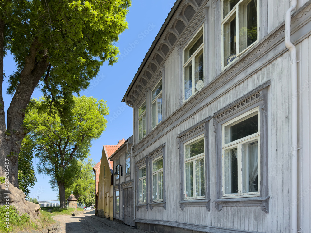 Happy walking in old Fredrikstad on a great warm summer day, with many old buildings, Norway	