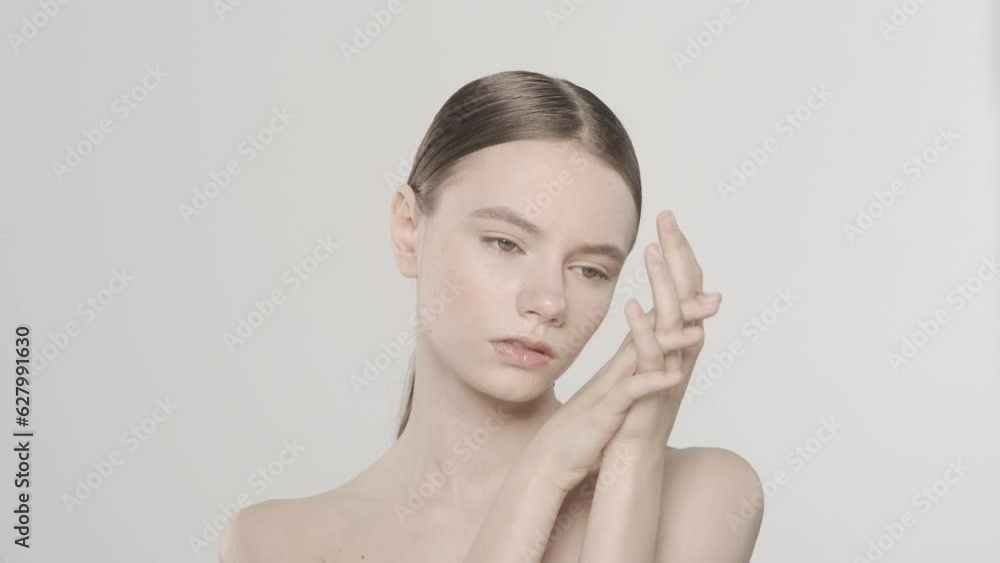 Beautiful brunette female touching her hand pure skin and looking at the camera HDR BT2020 HLG Material. Beautiful brunette female touching her hand pure skin and looking at the camera HDR BT2020 HLG Material.