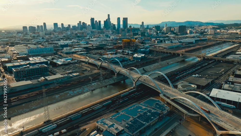 View of Los Angeles skyline with modern bridges and urban infrastructure during late afternoon sunshine