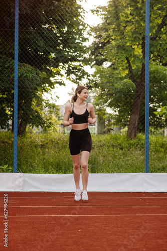 Caucasian sports woman doing warming exrcises outdoors on the sports ground © rostyslav84