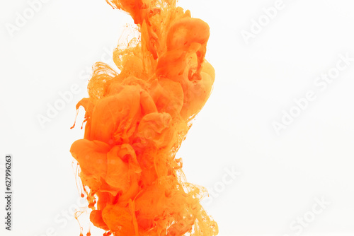 Close up of orange ink in water with copy space on white background