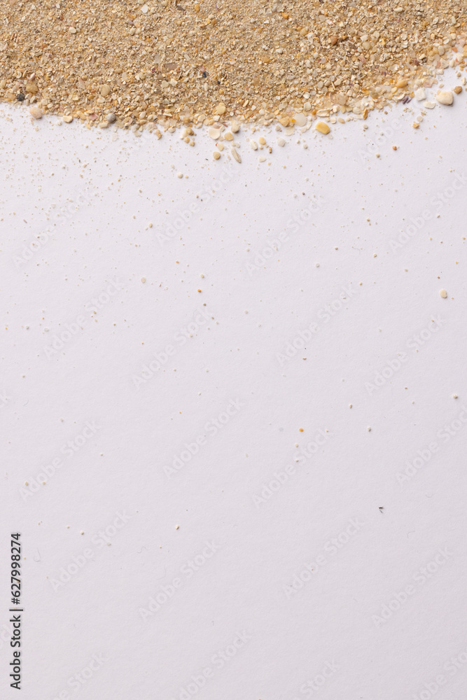 Close up of sand grains and copy space on white background Close up of sand grains and copy space on white background