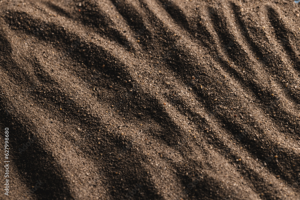 Close up of pattern of brown sand and copy space background Close up of pattern of brown sand and copy space background