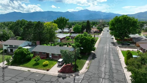 Colorado Springs, CO housing. Beautiful quaint neighborhood houses with view of rocky mountains. Aerial establishing shot of popular retirement location.