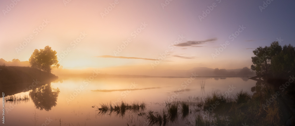 Misty lake at sunrise