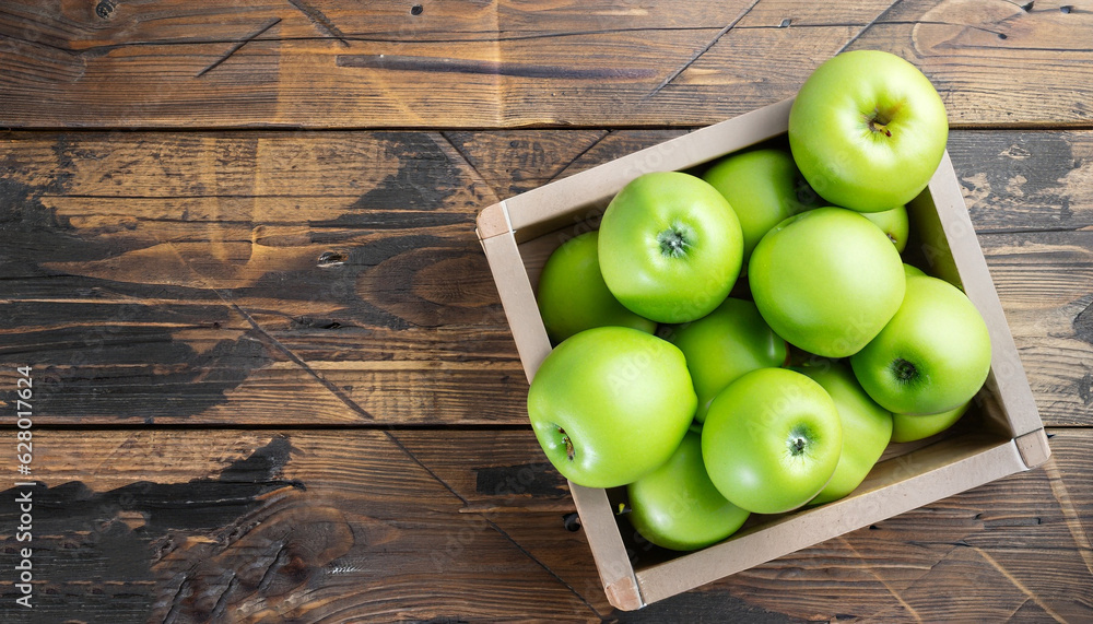 Ripe green apples box on wooden table. Top view with space for your text Ripe green apples box on wooden table. Top view with space for your text