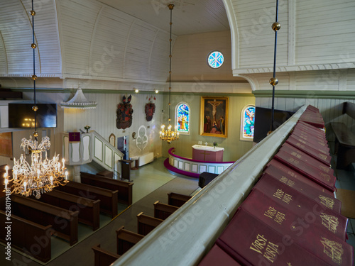 Tableau sur toile Interior of building of old Lutheran church at old cemetery in Finnish Tuusula town: basket with children's toys on bench