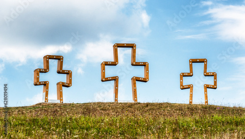 Three crosses on the horizon with sky behind in village Skalite, Slovakia photo