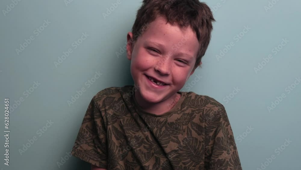 a little boy with a toothless smile.
