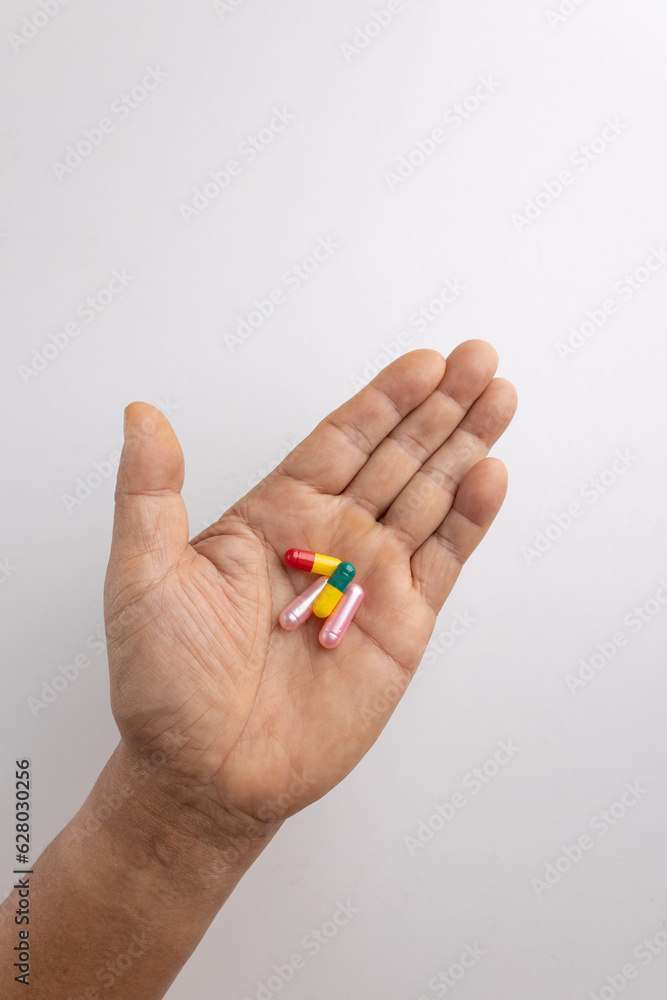 Four pill capsules in the hand. Four pill capsules in the hand.