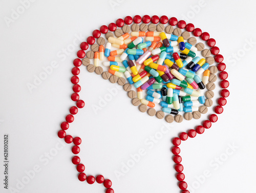head with mark and brain made from medicine pills.