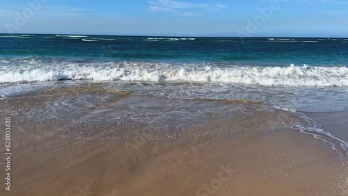 interesting wave patterns as the waves retreat from the beach photo
