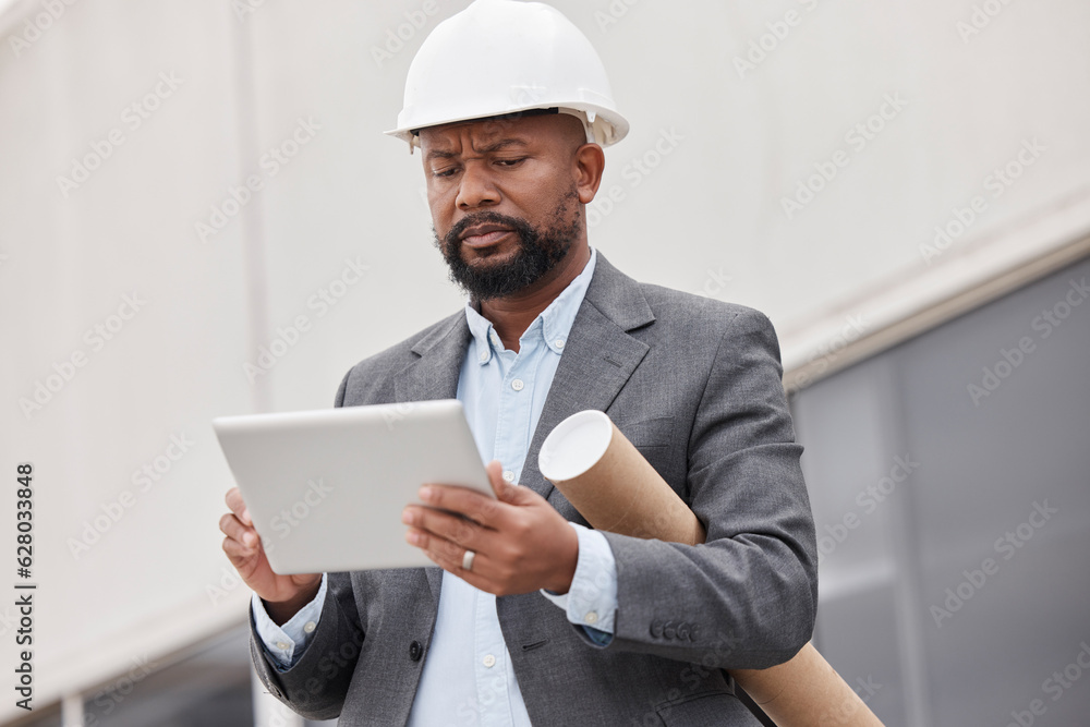 Tablet, blueprint and an architect manager planning a development project for commercial property. Technology, research and construction with a black man manager reading a floor plan design online Tablet, blueprint and an architect manager planning a development project for commercial property. Technology, research and construction with a black man manager reading a floor plan design online