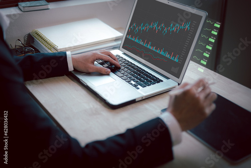 Hand of Businessman or trader touching showing a growing virtual hologram stock on Laptop, Concept invest in trading.planning and strategy, Stock market, Business growth, progress or success concept.