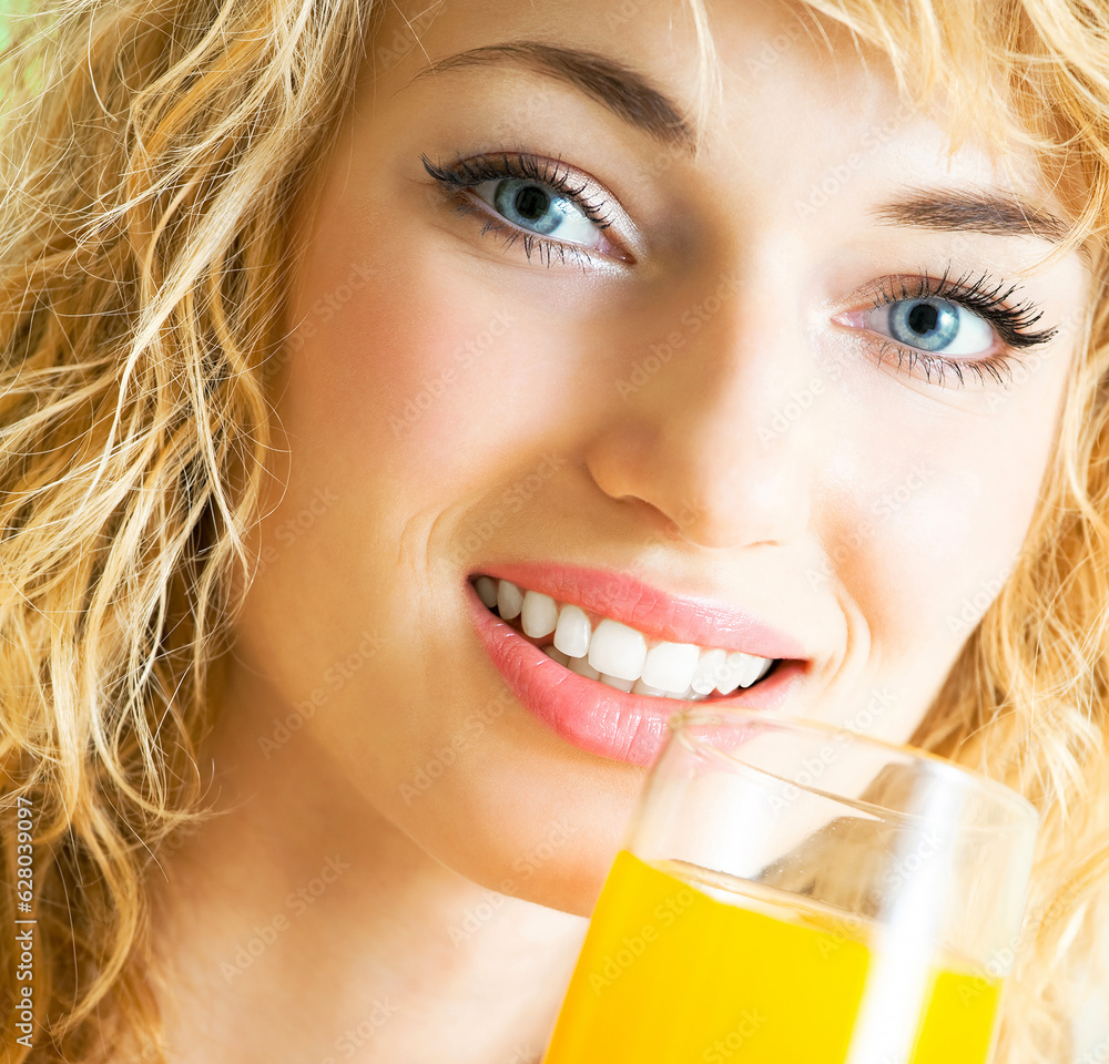 Portrait of happy smiling young beautiful blond woman drinking orange juice Portrait of happy smiling young beautiful blond woman drinking orange juice