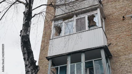 Smashed window, broken glass, Destroyed building. Building had smashed windows, broken frames, broken glass. Building bombed, window broke, glass damaged apartment, caused significant damage to house