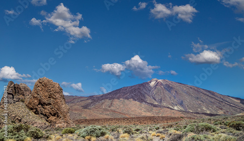 The famous El Teide volcano in Tenerife, Canary islands, Spain. Volcanic landscape in front a blue sky and white clouds.