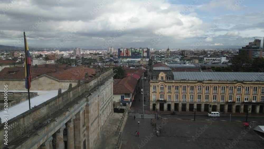 aerial of Bogota Colombia Palace of Justice in historical colonial downtown city centre with Colombian flag in cloudy moody day aerial of Bogota Colombia Palace of Justice in historical colonial downtown city centre with Colombian flag in cloudy moody day