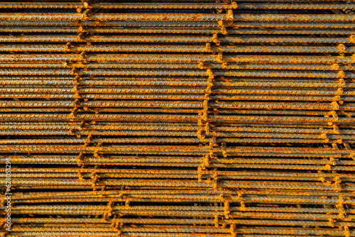 Stack of welded wire mesh, WWM, ready to be installed within a sidewalk concrete form.  photo