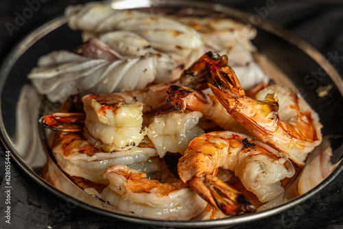 Photo of a delicious seafood dish with fresh shrimp served in a metal bowl
