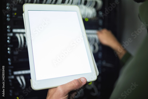 Screen, technician and hands with tablet for information on a server room for network analytics. Closeup, working and a programmer with mockup technology for system connectivity, coding and research