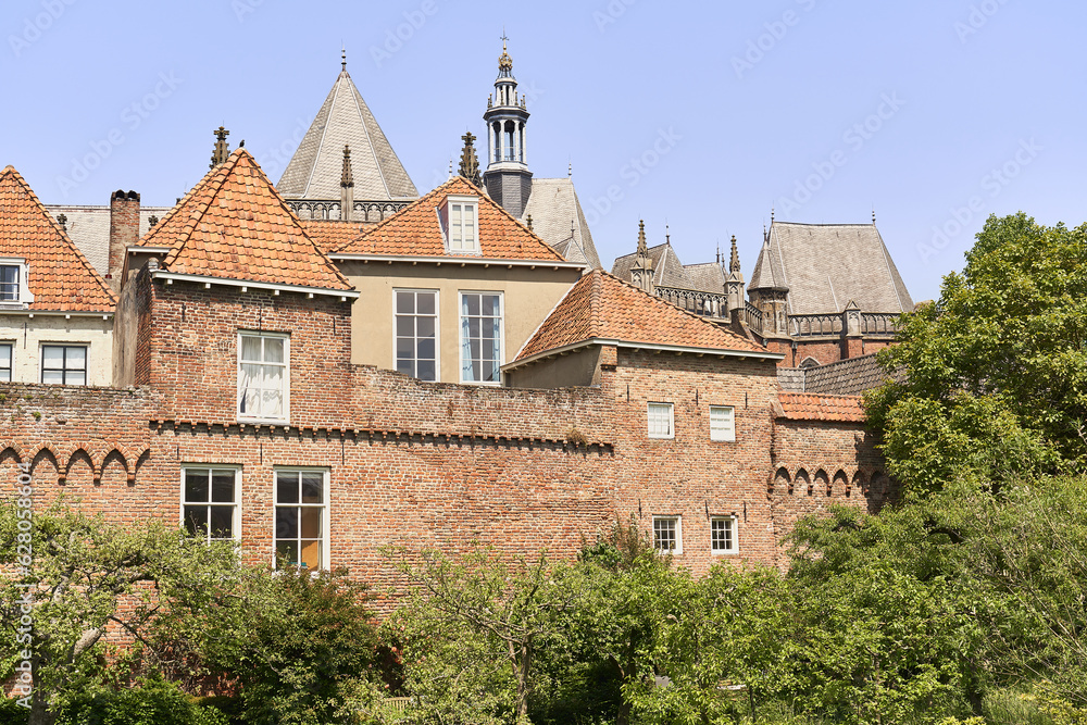 Zutphen's ancient city walls with homes and the Walburgis Church