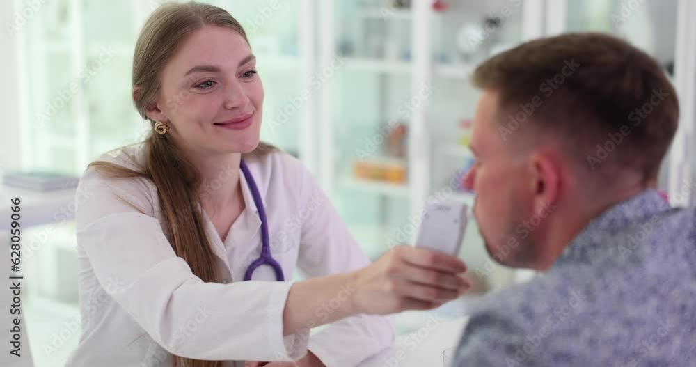 Man measures level of alcohol in blood with breathalyzer. Doctor checks patient for intoxication and drugs in clinic Man measures level of alcohol in blood with breathalyzer. Doctor checks patient for intoxication and drugs in clinic