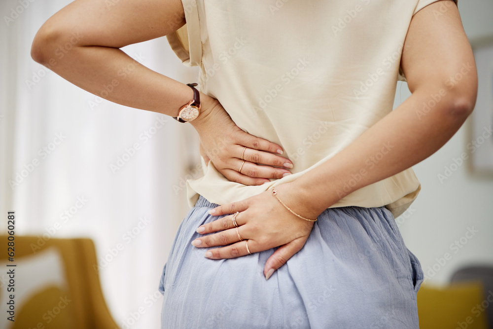 Back pain, hands and woman in a living room with problem, discomfort or arthritis in her home. Backache, spine and person with cramps, joint or posture in lounge with osteoporosis or fibromyalgia - obrazy, fototapety, plakaty 