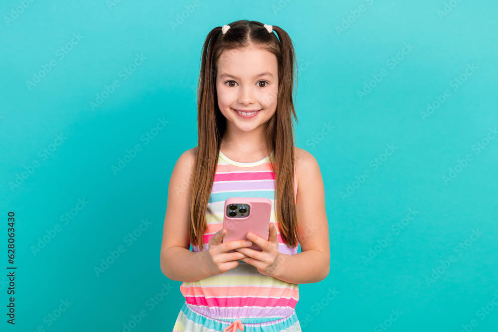 Φωτογραφία Portrait of little positive girl toothy smile hold use smart phone chatting isol