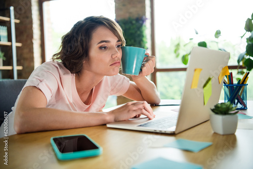 Bilde på lerret Photo of exhausted young girl cup coffee remote job browsing laptop overworked n