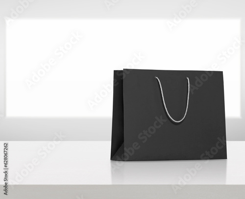 black paper bag on white wooden table