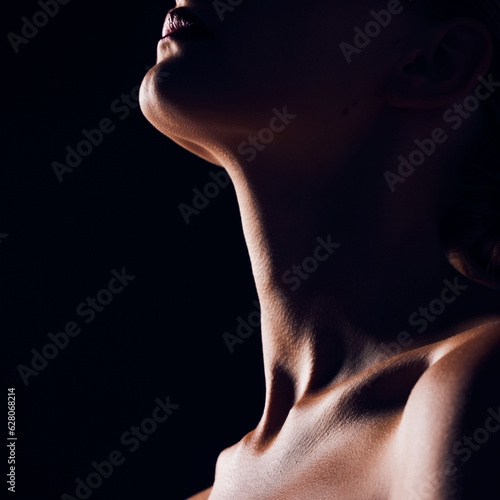 Skincare, neck and person on black background for creative lighting, shadow and silhouette. Aesthetic, beauty and closeup of body in dark studio with macro of skin for art deco, wellness and glow