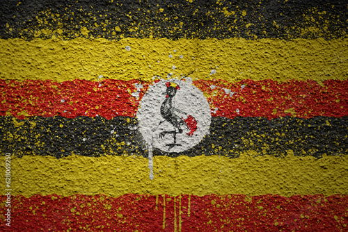 painted big national flag of uganda on a massive old cracked wall
