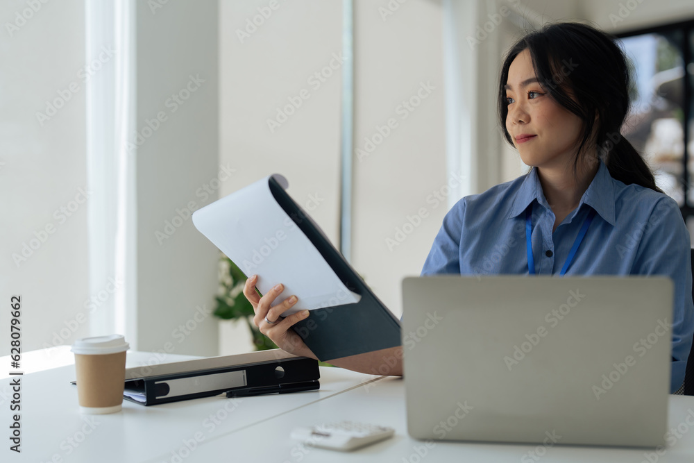 young businesswoman asian take notes at her desk in office. young businesswoman asian take notes at her desk in office.