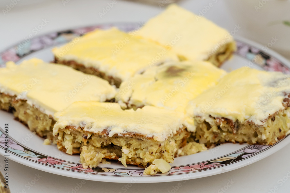 Traditional Bosnian savory pie - buckwheat pita ljevuša with feta cheese, zucchini and eggs
