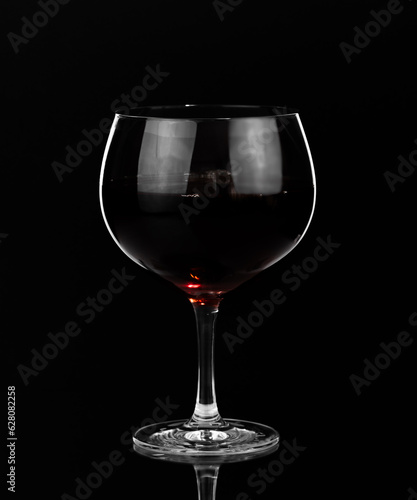 Glass of red wine on dark background. Happy hour and nightlife. Bar and restaurant.