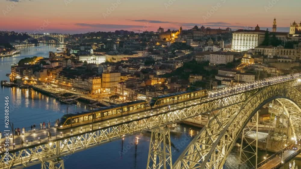 Sunset evening view of Porto, Portugal. Zoom out view of old city in Porto and bridgePonte Luis I with citylights Sunset evening view of Porto, Portugal. Zoom out view of old city in Porto and bridgePonte Luis I with citylights