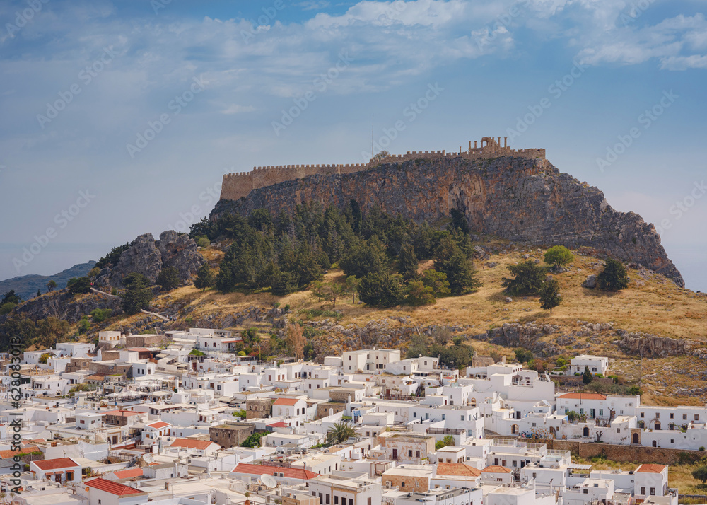 Lindos town in Greece aerial view in cloud summer day, white houses in Rhodes island , cityscape viewpoint traditional greek architecture, famous landmark and touristic destination concept