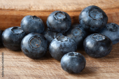 Blueberry. Fresh blueberries on a wooden surface close-up. Sprinkle blueberries. Scattered fresh blueberries. Healthy food concept. Selective focus